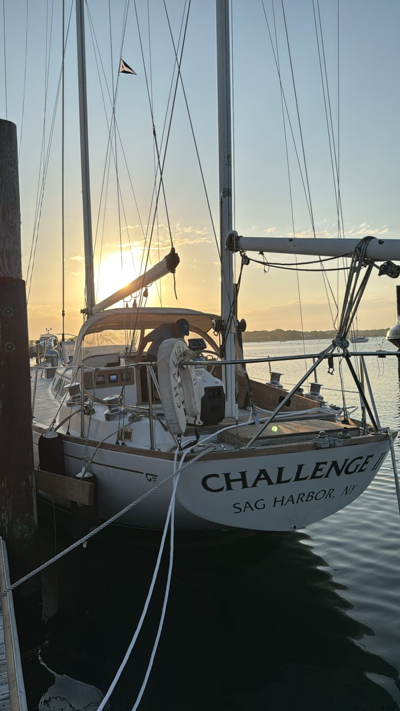 A yacht's transom at the dock at sunset